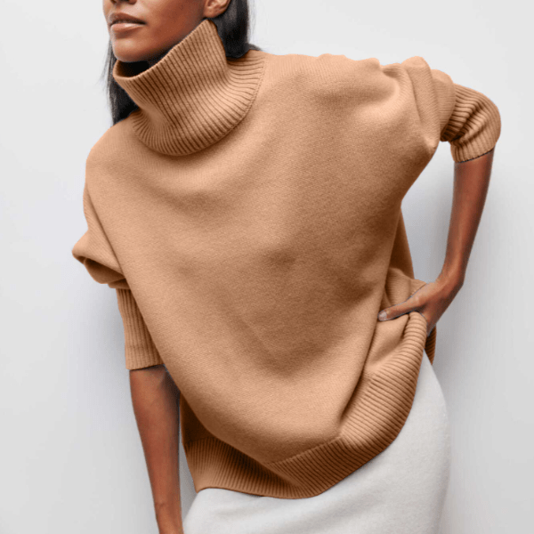 Person wearing a beige turtleneck sweater against a white background