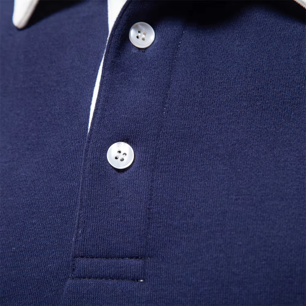 Close-up of a navy blue polo shirt with white buttons.