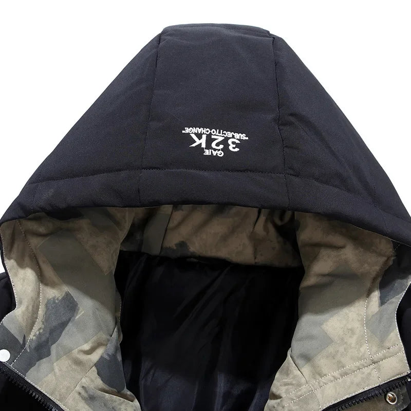 Close-up of a black hooded jacket with camouflage lining on a white background