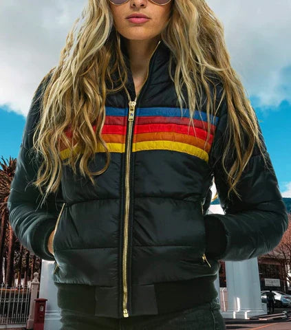 Person wearing a black puffer jacket with colorful stripes in an outdoor setting