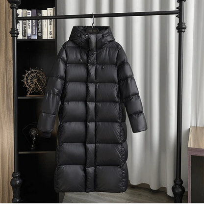 Black puffer coat hanging on a rack against a neutral background