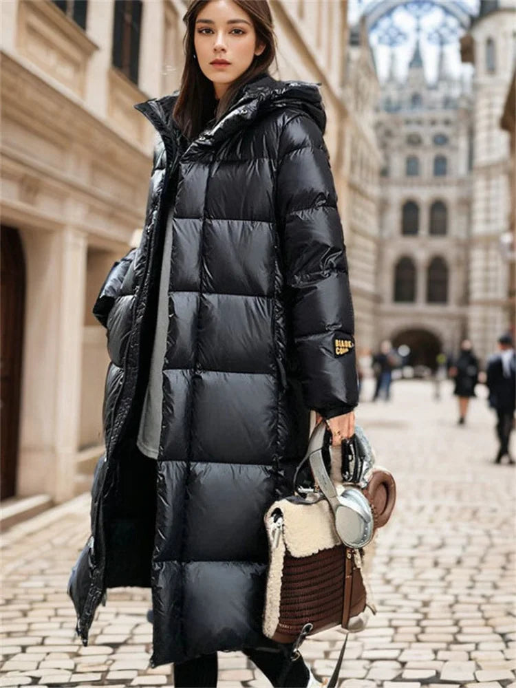 Woman wearing a long black puffer coat in an urban setting