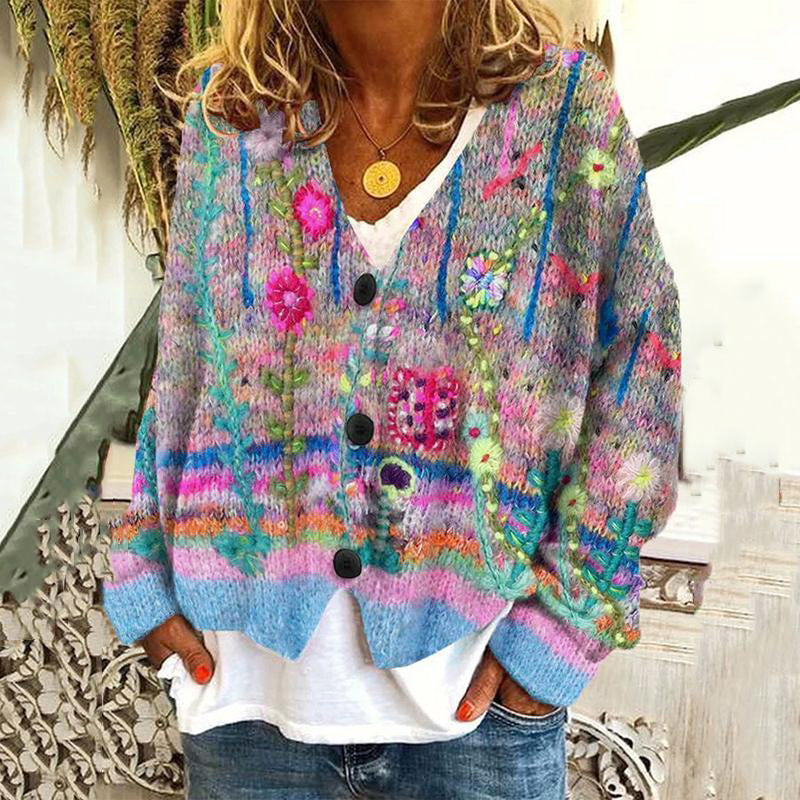 Person wearing a colorful knitted cardigan with floral patterns.