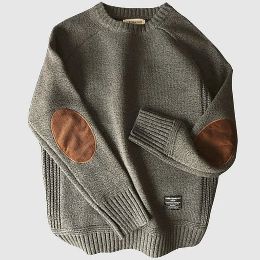 Gray sweater with brown leather patches on a light gray background