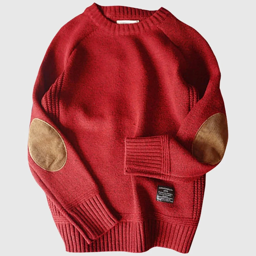 Red sweater with brown elbow patches on a light gray background