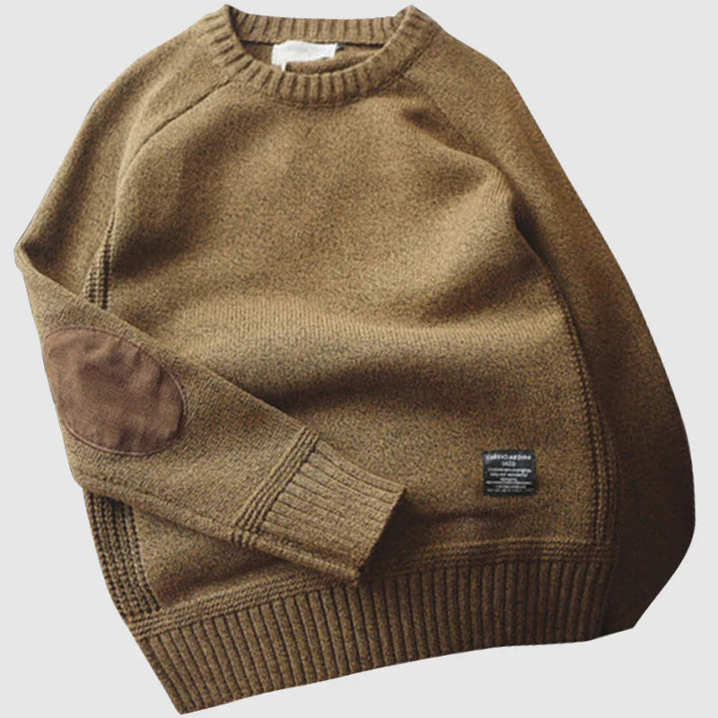 Brown sweater with a brand label on a light gray background