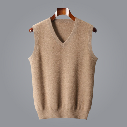 Beige sweater vest on a wooden hanger against a gray background