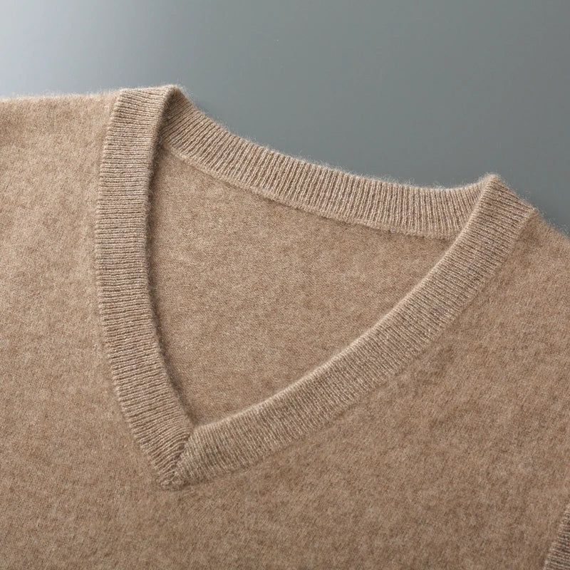 Close-up of a brown sweater with a V-neck on a gray background