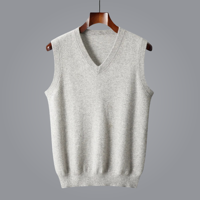Gray sleeveless sweater on a wooden hanger against a gray background