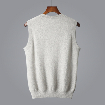 Gray sleeveless sweater vest on a hanger against a gray background