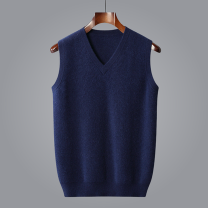 Blue sweater vest on a hanger against a gray background