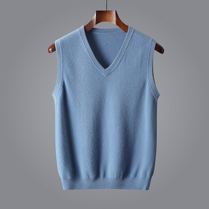 Blue sweater vest on a wooden hanger against a gray background
