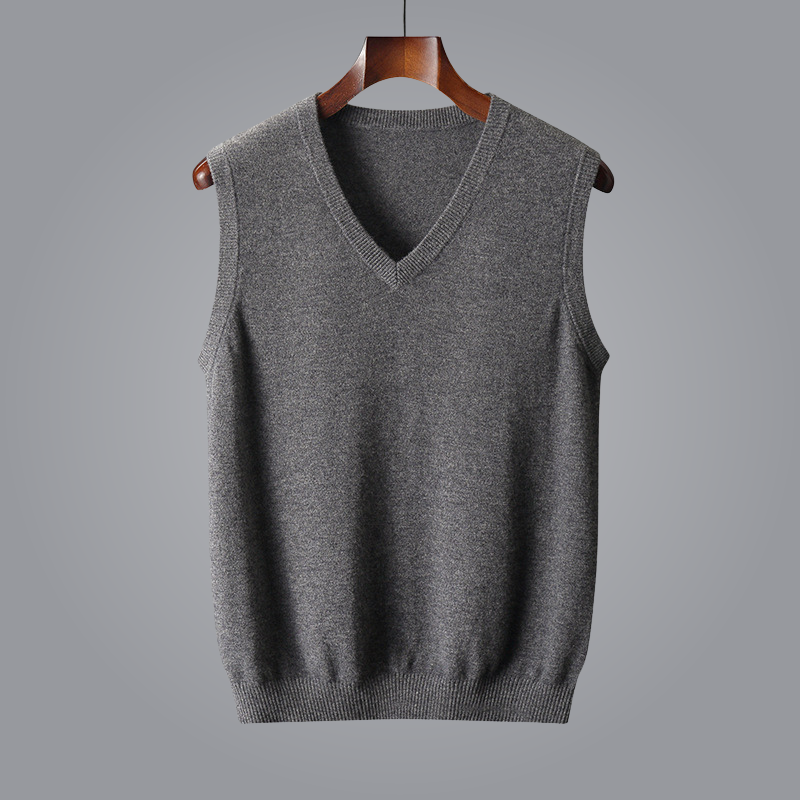 Gray sleeveless sweater on a hanger against a gray background
