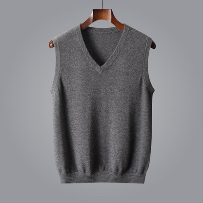 Gray sleeveless sweater on a hanger against a gray background