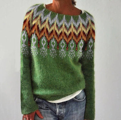 Green sweater with a colorful pattern worn by a person on a plain background