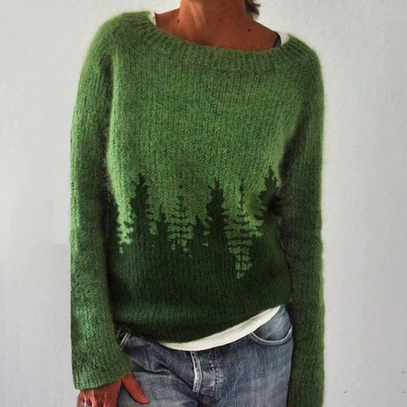 Green knitted sweater worn by a person on a plain background