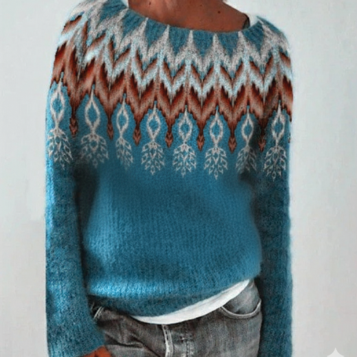 Teal sweater with patterned design worn by a person on a plain background
