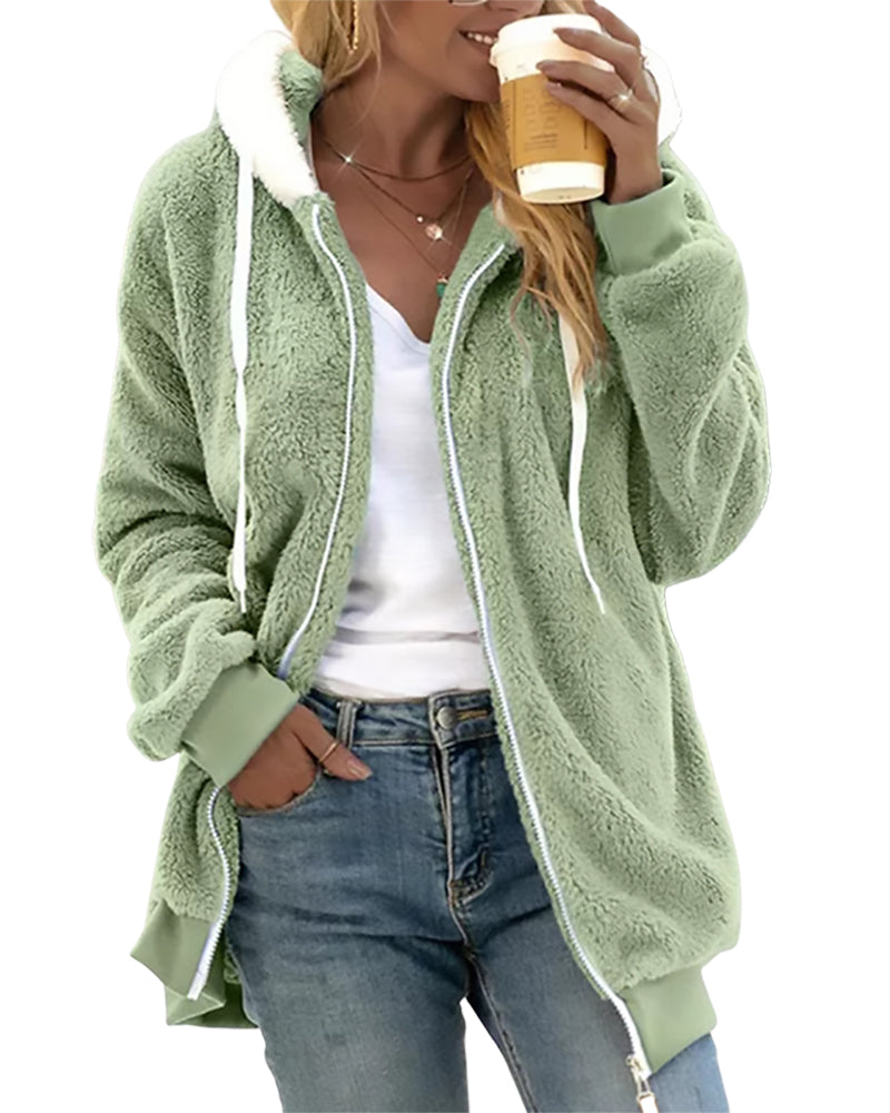 Person wearing a green fleece jacket holding a coffee cup on a white background
