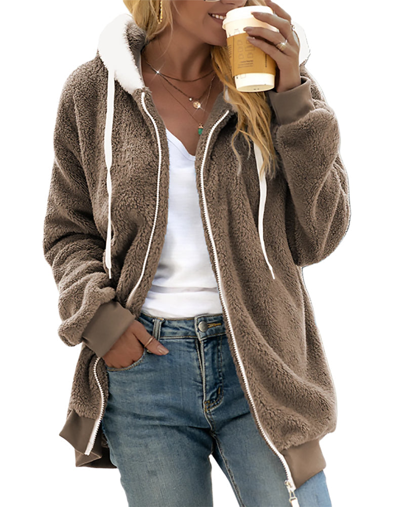 Person wearing a brown fleece jacket with white trim, holding a coffee cup.