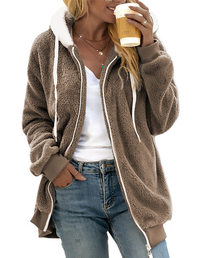 Person wearing a brown fleece jacket with white trim, holding a coffee cup.