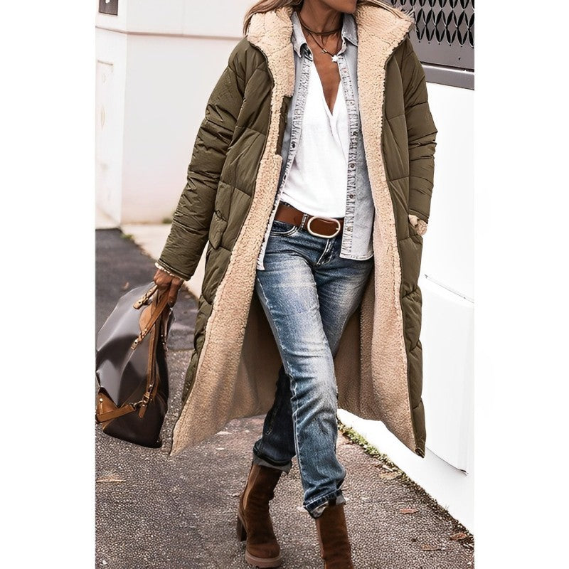 Person wearing a long olive green puffer coat with beige lining, white shirt, blue jeans, and brown boots.