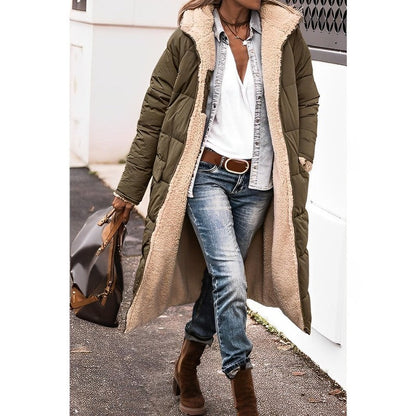 Person wearing a long olive green puffer coat with beige lining, white shirt, blue jeans, and brown boots.
