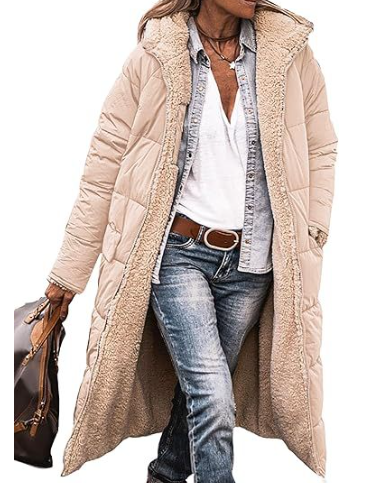 Person wearing a beige quilted jacket with a white shirt and blue jeans on a white background