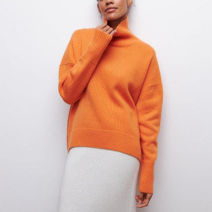 Person wearing an orange sweater against a white background