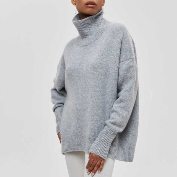 Person wearing a light gray turtleneck sweater on a white background