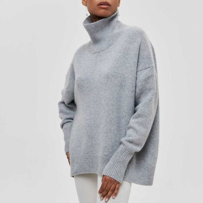Person wearing a light gray turtleneck sweater on a white background