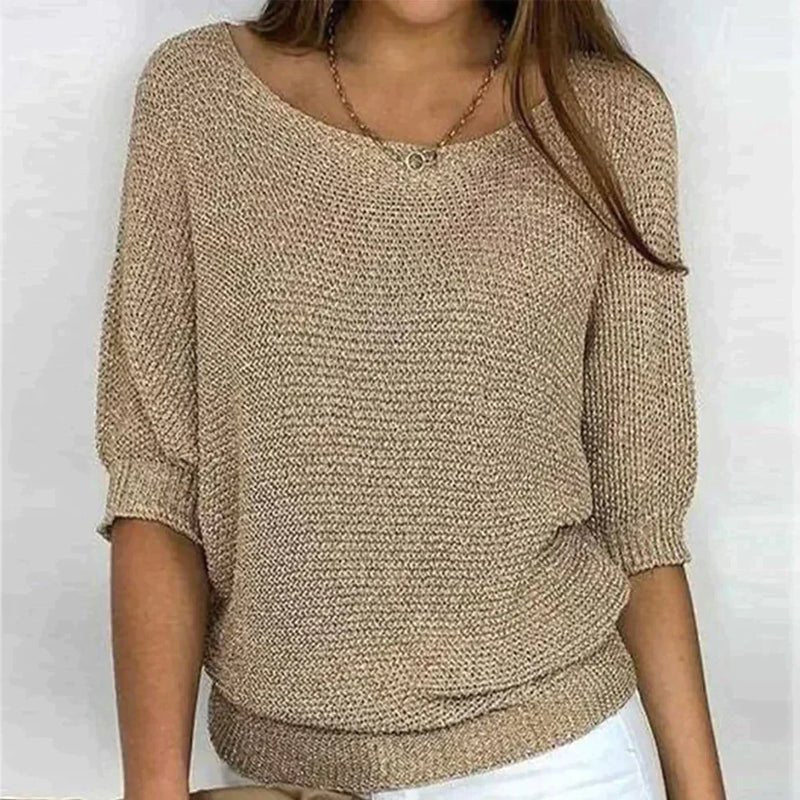 Beige knitted sweater worn by a person on a white background