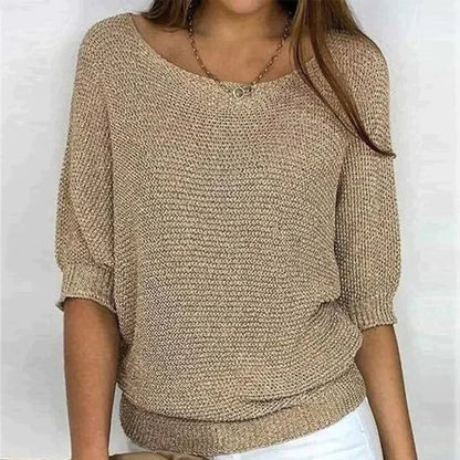 Beige knitted sweater worn by a person on a white background