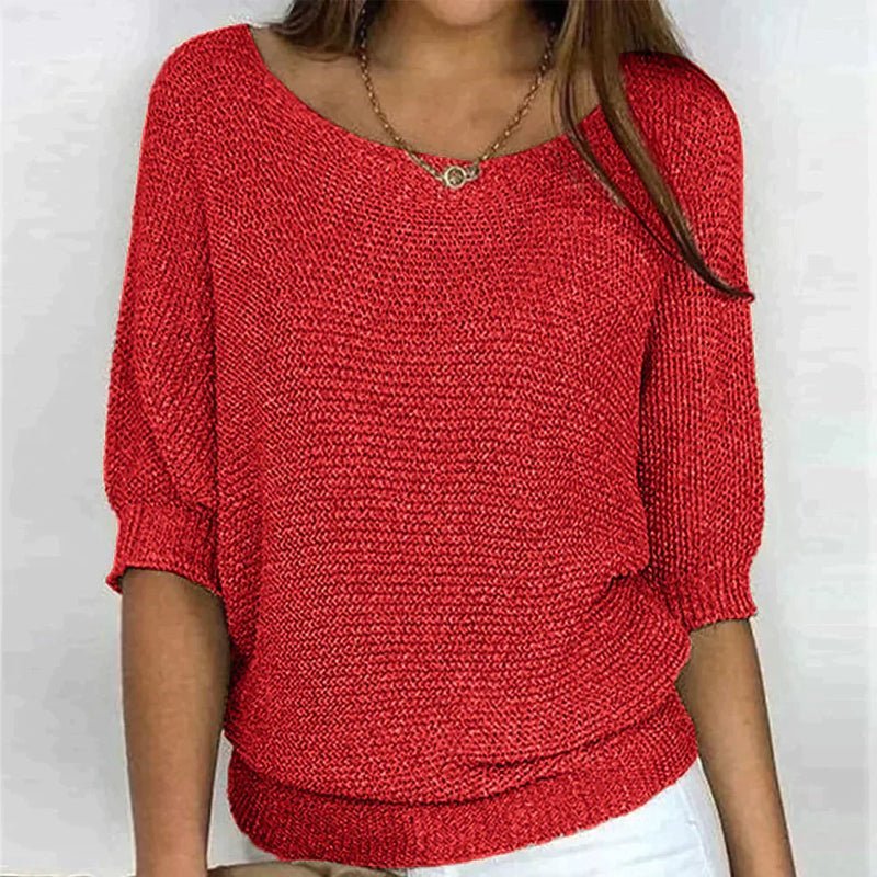 Red knitted sweater worn by a person on a white background