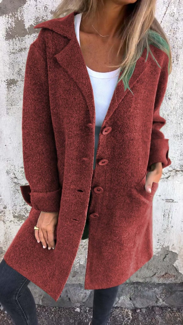 Person wearing a red coat with a neutral background