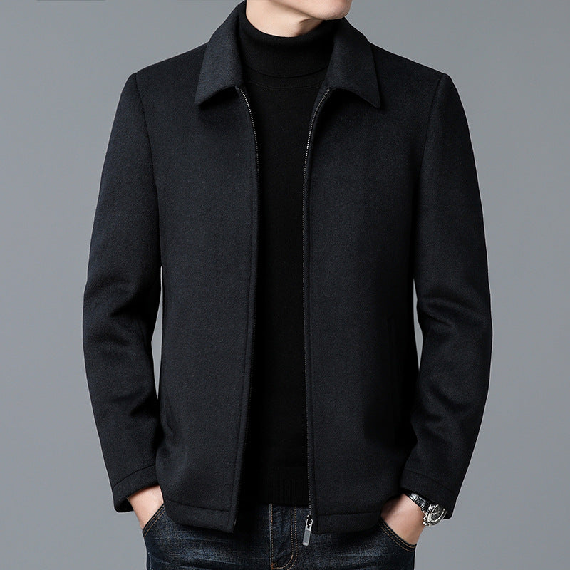 Black coat worn by a person on a gray background