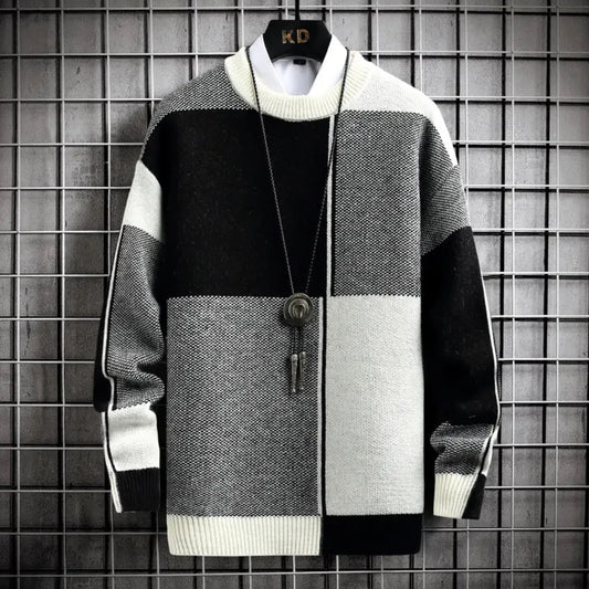 Color-blocked sweater with a key pendant on a grid background