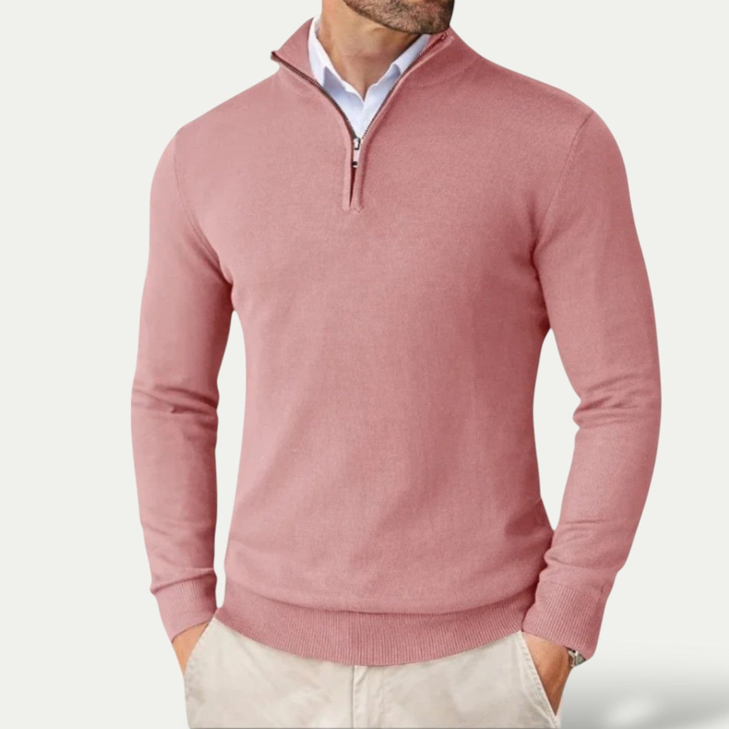 Pink half-zip sweater worn by a person on a light gray background