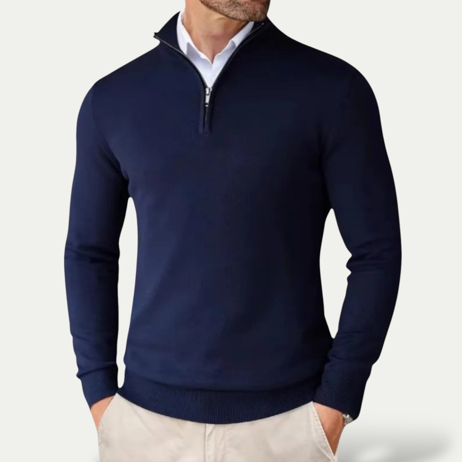Navy blue quarter-zip sweater worn by a person on a light gray background