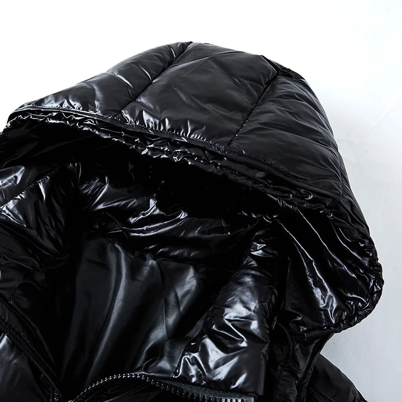 Close-up of a black puffer jacket with shiny texture on a white background