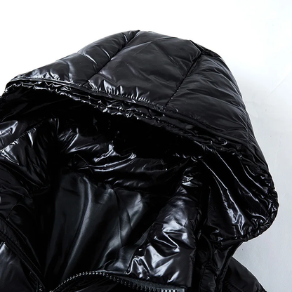 Close-up of a black puffer jacket with shiny texture on a white background