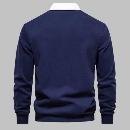 Navy blue sweater on a gray background