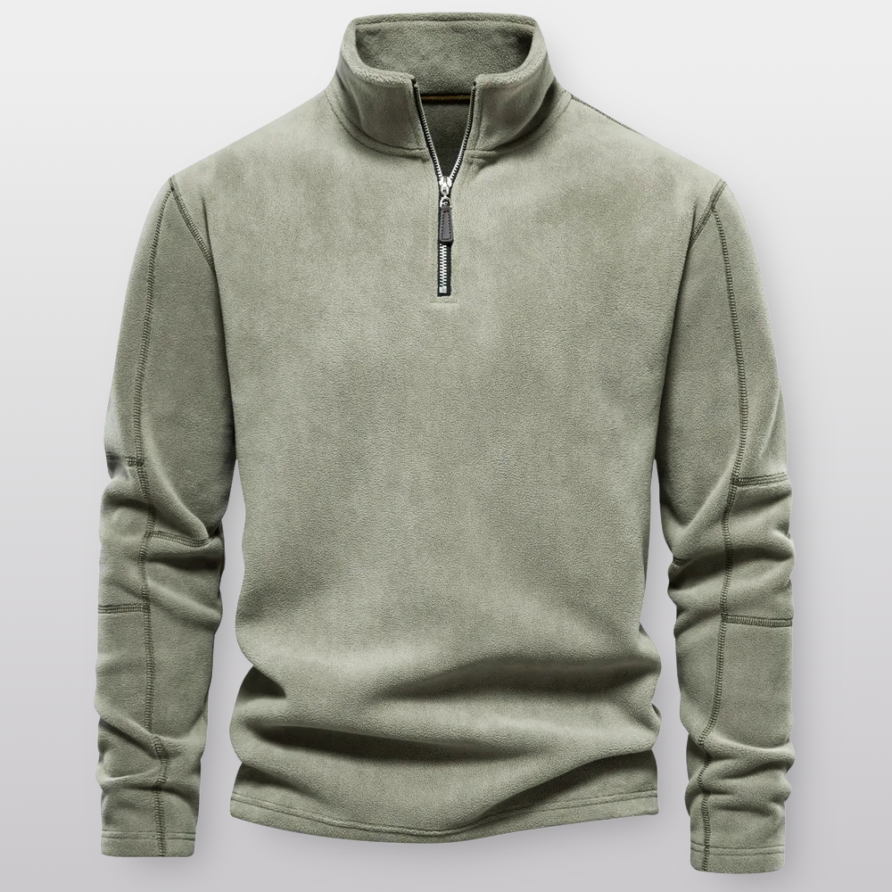 Green fleece pullover with a zipper on a light gray background