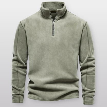 Green fleece pullover with a zipper on a light gray background