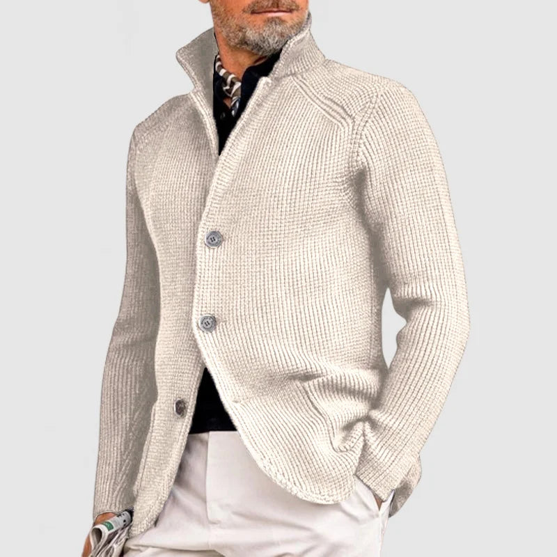 Man wearing a beige knitted cardigan on a light gray background