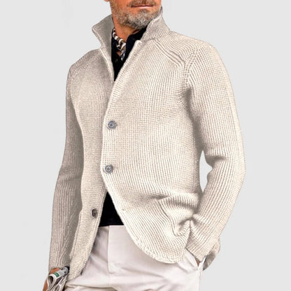 Man wearing a beige knitted cardigan on a light gray background