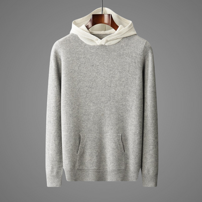 Gray hoodie with white hood on a hanger against a gray background