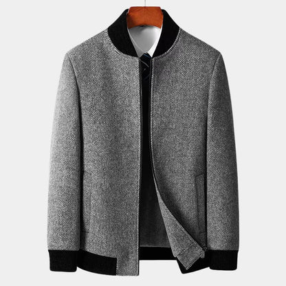 Gray textured jacket with black trim on a white background