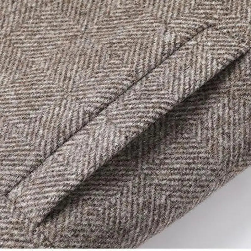 Close-up of textured brown fabric with a geometric pattern on a white background