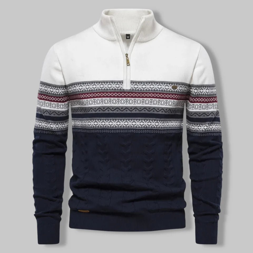 Navy and white sweater with patterned sleeves on a gray background