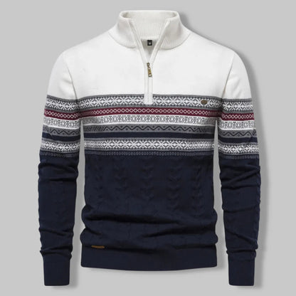 Navy and white sweater with patterned sleeves on a gray background
